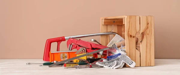 Overturned Box Different Construction Tools Table Beige Background — Stock Photo, Image