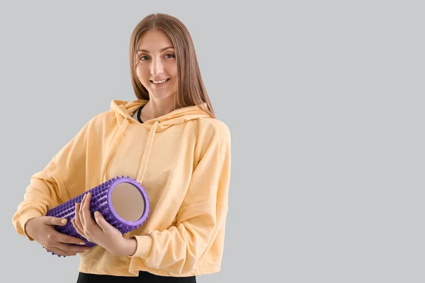 Young Woman Purple Foam Roller Light Background — Stockfoto