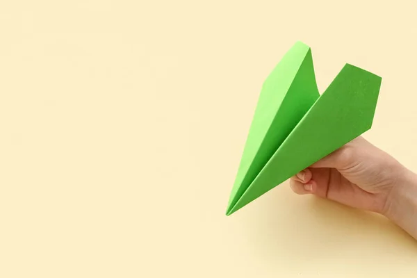 Woman Green Paper Plane Beige Background Closeup — Stock Photo, Image