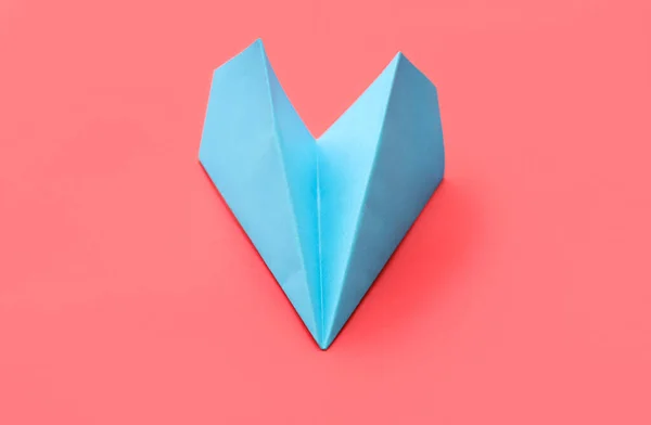 Blue paper plane on red background