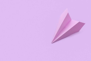 Lilac paper plane on color background