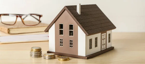 House model and money on table. Concept of buying new property