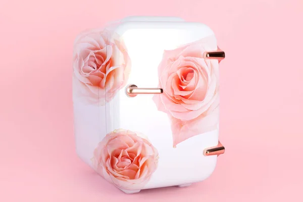 Small cosmetic refrigerator with floral print on pink background