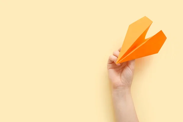 Woman Orange Paper Plane Beige Background — Stock Photo, Image