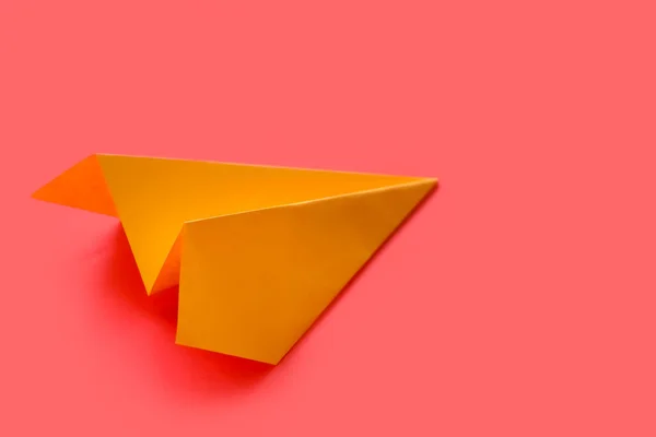 Yellow paper plane on red background