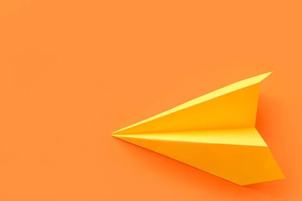 Yellow paper plane on orange background