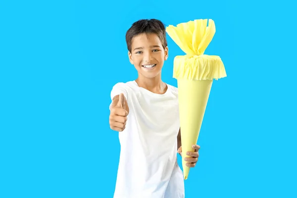 Little Boy Yellow School Cone Showing Thumb Blue Background — Stock fotografie