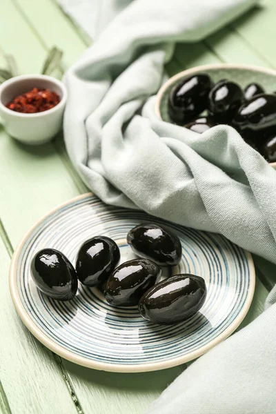 Plate Tasty Black Olives Napkin Color Wooden Background Closeup — Stock Fotó