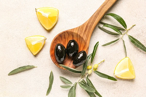 Composition Wooden Spoon Tasty Black Olives Leaves Lemon Pieces Light — Foto Stock