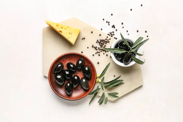 Composition Bowls Tasty Black Olives Cheese Spices Light Background — Photo