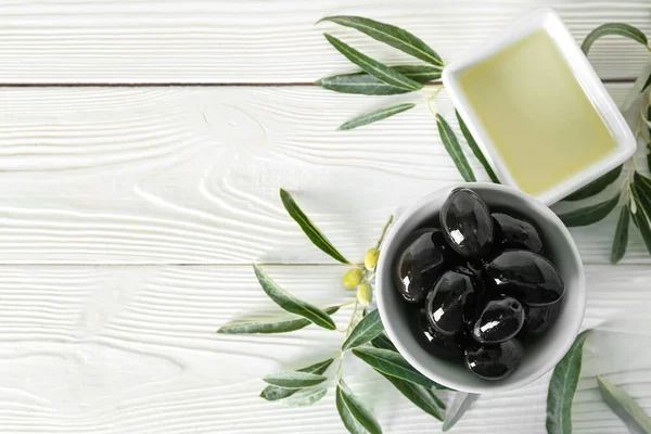 Bowls Tasty Black Olives Oil Leaves Light Wooden Background — Foto de Stock