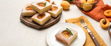 Composition with tasty cut apricot pie on light background