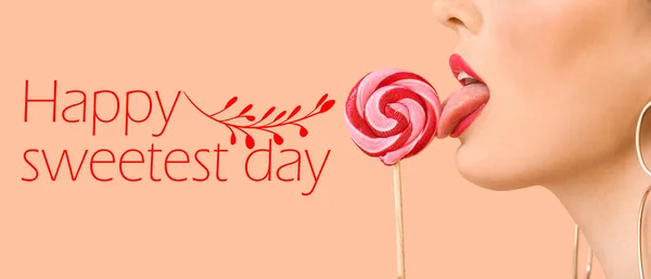 Sexy young woman with lollipop on beige background, closeup. Happy Sweetest Day