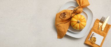 Beautiful autumn table setting with pumpkin on light background with space for text