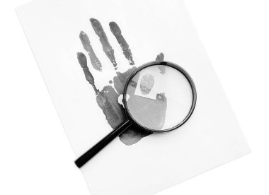 Magnifier and paper sheet with palm and finger prints on white background