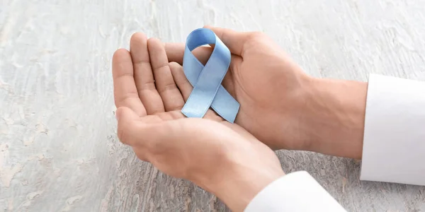 Male Hands Blue Ribbon Light Background Prostate Cancer Awareness Concept — Foto de Stock