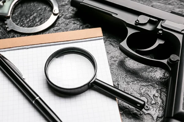 Notebook Pen Magnifier Gun Handcuffs Dark Background — 스톡 사진
