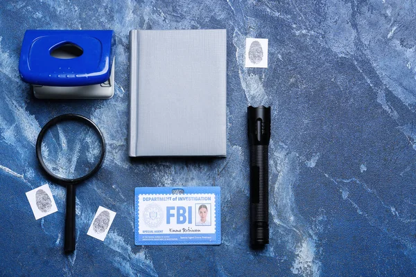 Notebook with document of FBI agent and accessories on color background
