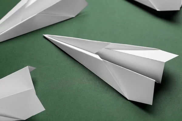 Paper planes on green background