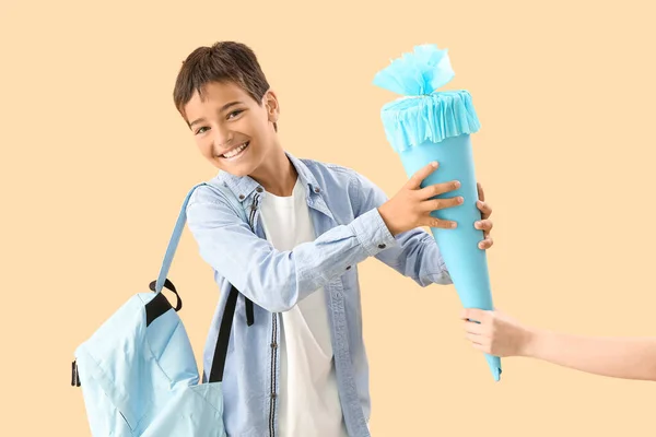 Little Boy Receiving Blue School Cone Beige Background — Stock Photo, Image