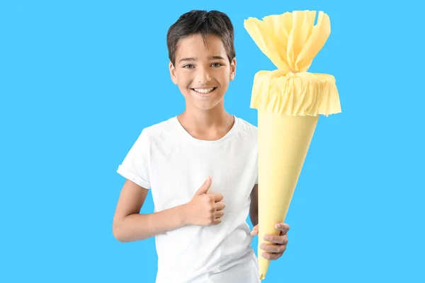 Little Boy Yellow School Cone Showing Thumb Blue Background — Stockfoto
