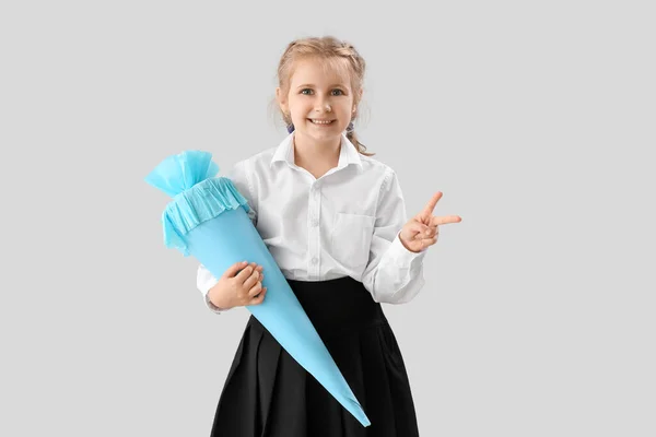 Cute Little Girl Blue School Cone Showing Victory Gesture Light — Stockfoto