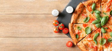 Delicious pizza Margarita on wooden background with space for text, top view