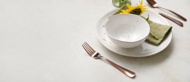 Beautiful table setting with fresh sunflower on white background with space for text