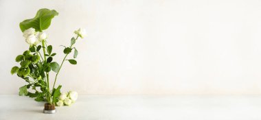 Beautiful ikebana on light background with space for text