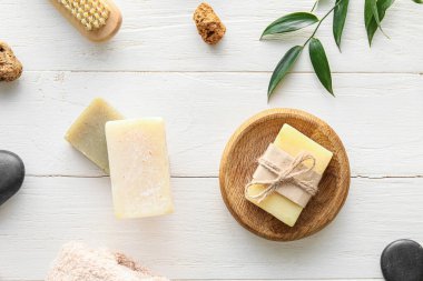 Soap bars on light wooden background