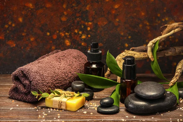 Beautiful spa composition with plant branch on wooden table