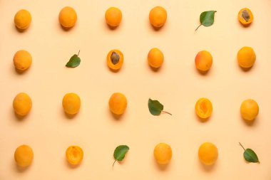Many ripe apricots on color background