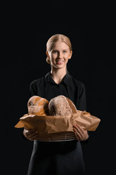 Young Woman Holding Basket Fresh Bread Black Background — Zdjęcie stockowe