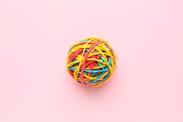 Colorful rubber band ball on pink background