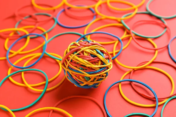 Colorful rubber band ball on red background