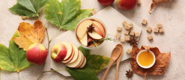 Glass cup of tasty mulled wine and ingredients on table, top view