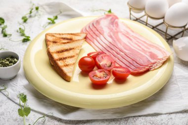 Plate with raw bacon, tomatoes and toasts on table, closeup