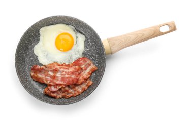 Frying pan with tasty fried egg and bacon on white background