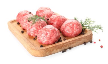 Board with raw meat balls, peppercorns and dill on white background