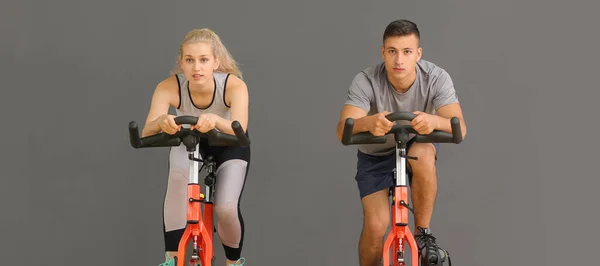 Young People Training Exercise Bikes Grey Background — Stockfoto