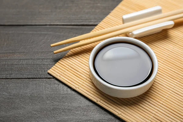 Bowl Soy Sauce Chopsticks Bamboo Mat Dark Wooden Background Closeup — Stock Photo, Image