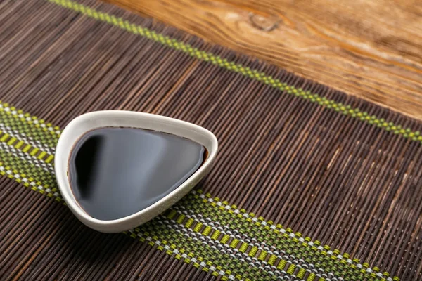 Bowl Soy Sauce Bamboo Mat Wooden Background Closeup — Stock Photo, Image