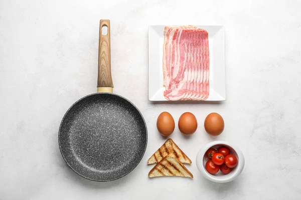 Composition Frying Pan Raw Eggs Bacon Toasts Tomatoes Light Background — Stock Photo, Image