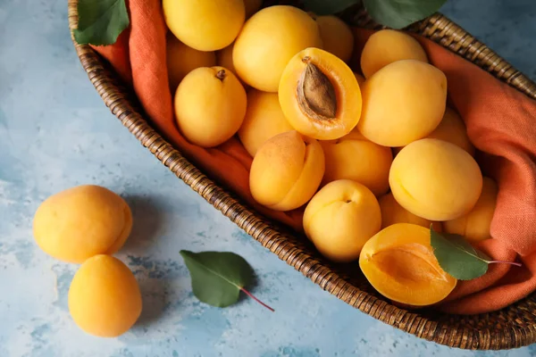 Wicker Basket Tasty Ripe Apricots Color Background Closeup — Stockfoto