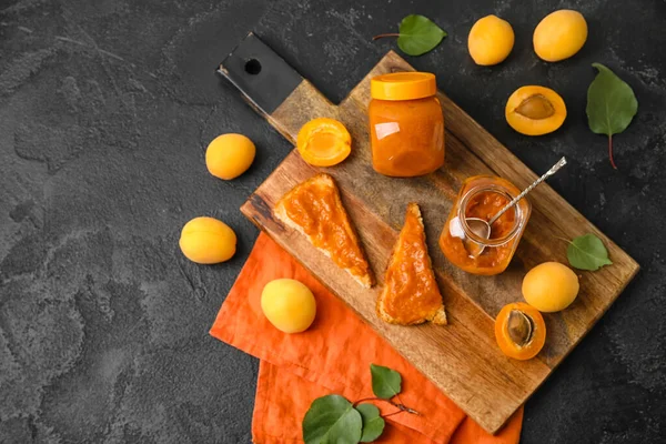 Composition Wooden Board Tasty Sandwiches Apricot Jam Fruits Dark Background — Stockfoto