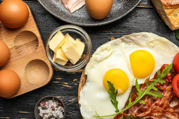 Plate Tasty Fried Eggs Bacon Butter Dark Wooden Table Closeup — Stock Photo, Image