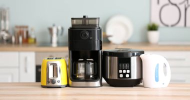 Different household appliances on kitchen table