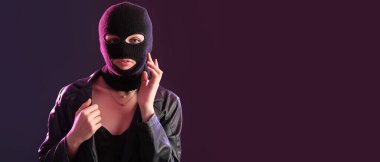 Young woman in balaclava on black background with space for text