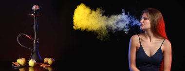 Young woman smoking hookah on dark background with space for text