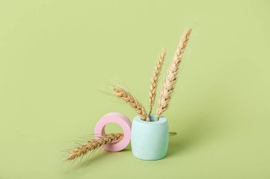 Showcase pedestals and wheat ears on green background